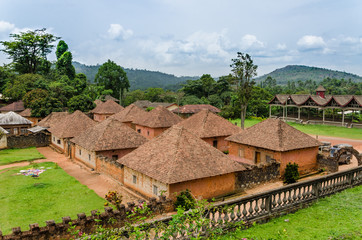 Fototapeta na wymiar Traditional palace of the Fon of Bafut with brick and tile buildings and jungle environment, Cameroon, Africa