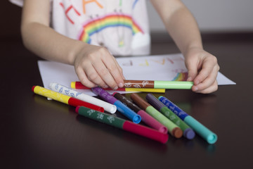  kids  draw rainbows and write the word happiness, kids hands  drawing