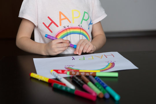  kids  draw rainbows and write the word happiness, kids hands  drawing