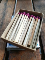 Close up of match stick and match box