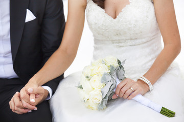 Wedding couple holding hands outdoors
