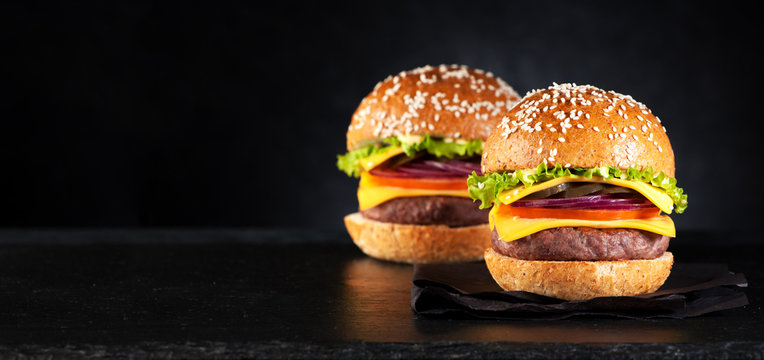 burgers hamburgers cheeseburgers on a black background