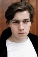 Fototapeta premium Young elegant trendy boy outdoors, wearing black and white clothing