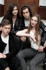 Fototapeta premium Young elegant trendy friends outdoors, wearing black and white clothing