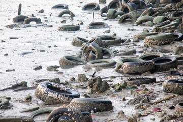 Fototapeta premium Dirty muddy beach showing a dump site