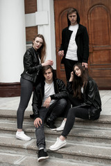 Fototapeta premium Young elegant trendy friends outdoors, wearing black and white clothing