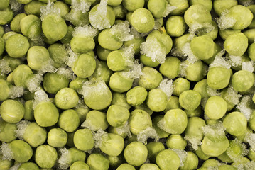 Close-up of frozen green peas with ice crystals. Food background.