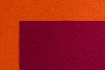 Fototapeta premium Eva foam ethylene vinyl acetate red surface on orange sponge plush background