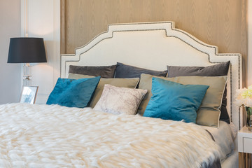 luxury bedroom with blue pillows on bed