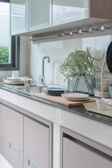 modern kitchen room with sink on top granite counter