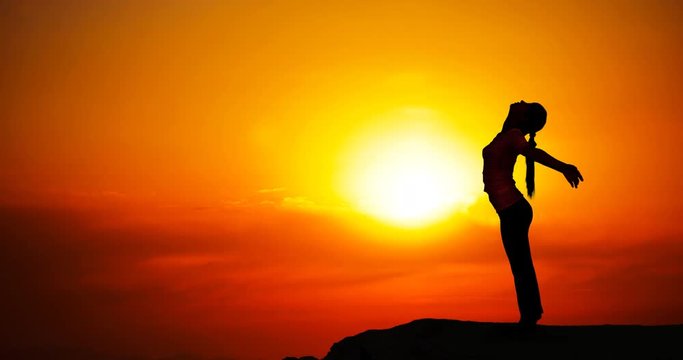 woman doing yoga outdoors at sunrise