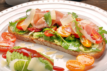 Avocado sandwich on fresh bread with arugula