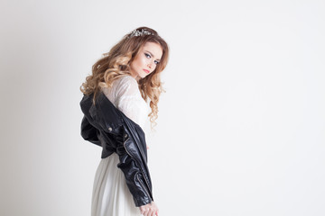 bride in white dress and leather jacket