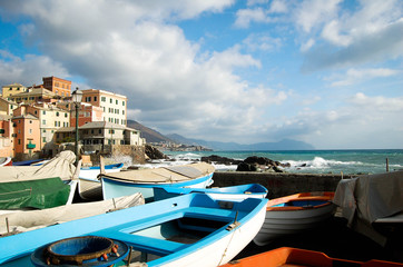 Fototapeta na wymiar view of touristic area 'boccadasse' in genoa italy and blue sky with clouds in the background