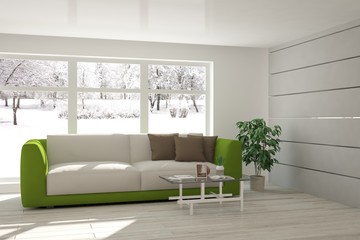 White interior design with sofa and winter landscape in window