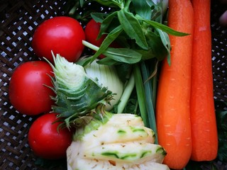 Close up of colorful fresh fruit and vegetable on a bamboo cart