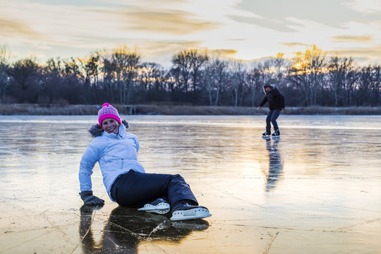 Cheerful woman skating on the lake.