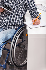 Smart disabled guy studying at home