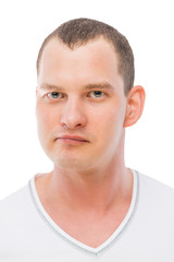 Fototapeta premium Vertical portrait of a man's face brunette on a white background