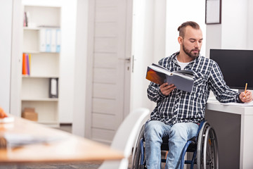 Smart disabled guy spending his free time studying