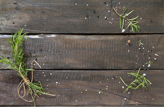 Sprigs of rosemary tied with string on a wooden table. Copy spac