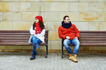 Young couple looking in different directions . Insult each other