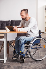 Focused handicapped man watching morning news