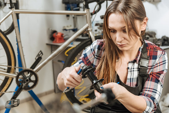 Involved young mechanic repairing in the work shop