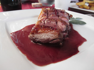 Duck breast on Sangiovese red wine sauce . Italian recipe