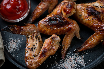 Close-up of bbq chicken wings with sesame, sea salt and sauce