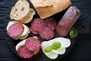 Bruschettas with baguette, salami and mozzarella, close-up