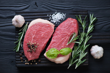 Above view of raw fresh beef medallions with seasonings
