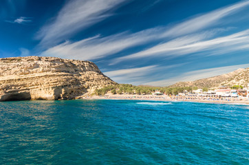 Fototapeta na wymiar Matala beach on Crete island, Greece. View from the rocks. There are many caves near the beach.