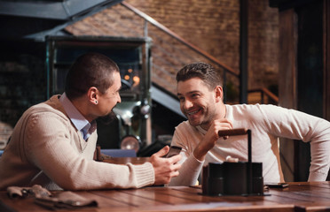 Happy pleasant men speaking to each other