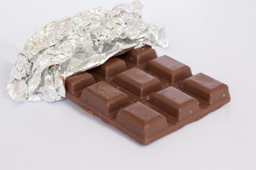 Chocolate bars in foil wrapper isolated on white background