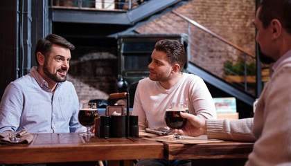 Handsome pleasant man listening to his friend