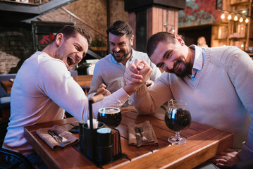 Positive nice men deciding who is stronger