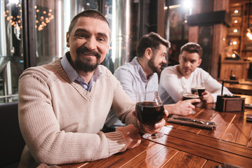 Delighted bearded man looking at you