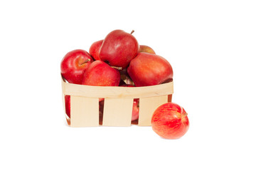 Fresh red apples in wooden basket isolated, autumn harvest