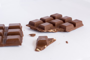 Chopped chocolate bar isolated on white background