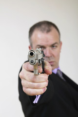 man in suit with gun