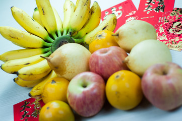various fruits in chinese new year, orange, watermelon, apples, pears and bananas