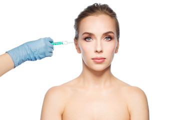 woman face and hand with syringe making injection