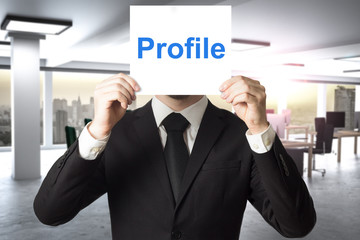 businessman hiding face behind sign profile