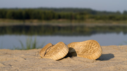 A pair of sports gym shoes on a sand