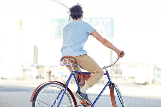 hipster man riding fixed gear bike