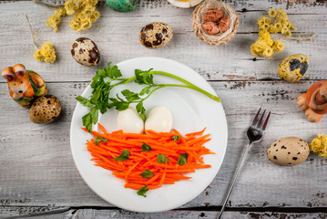 Idea for the children's lunch on Easter: a salad of fresh carrots with parsley and eggs, decorated in the form of a bird's nest