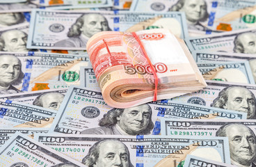 Folded five thousandths banknotes of russian roubles on dollars