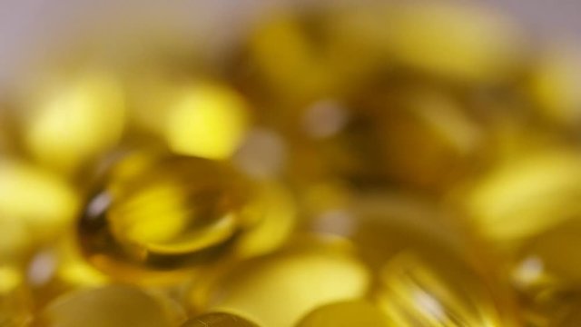 4K Blurred to focused shot of cod liver oil capsules