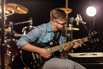man playing guitar at studio rehearsal